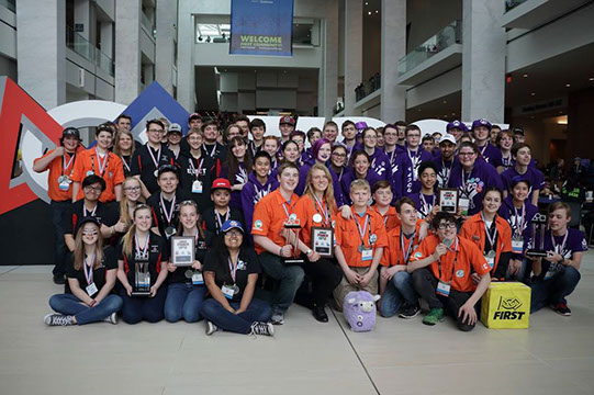 A group photo of our alliance team with medals and trophy's.