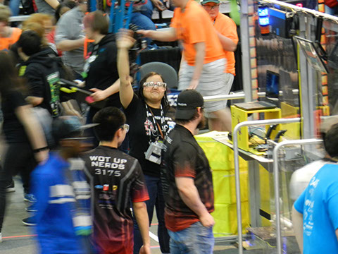 Cayla, one of our student coaches, waving to the crowd after setting up the driving station.